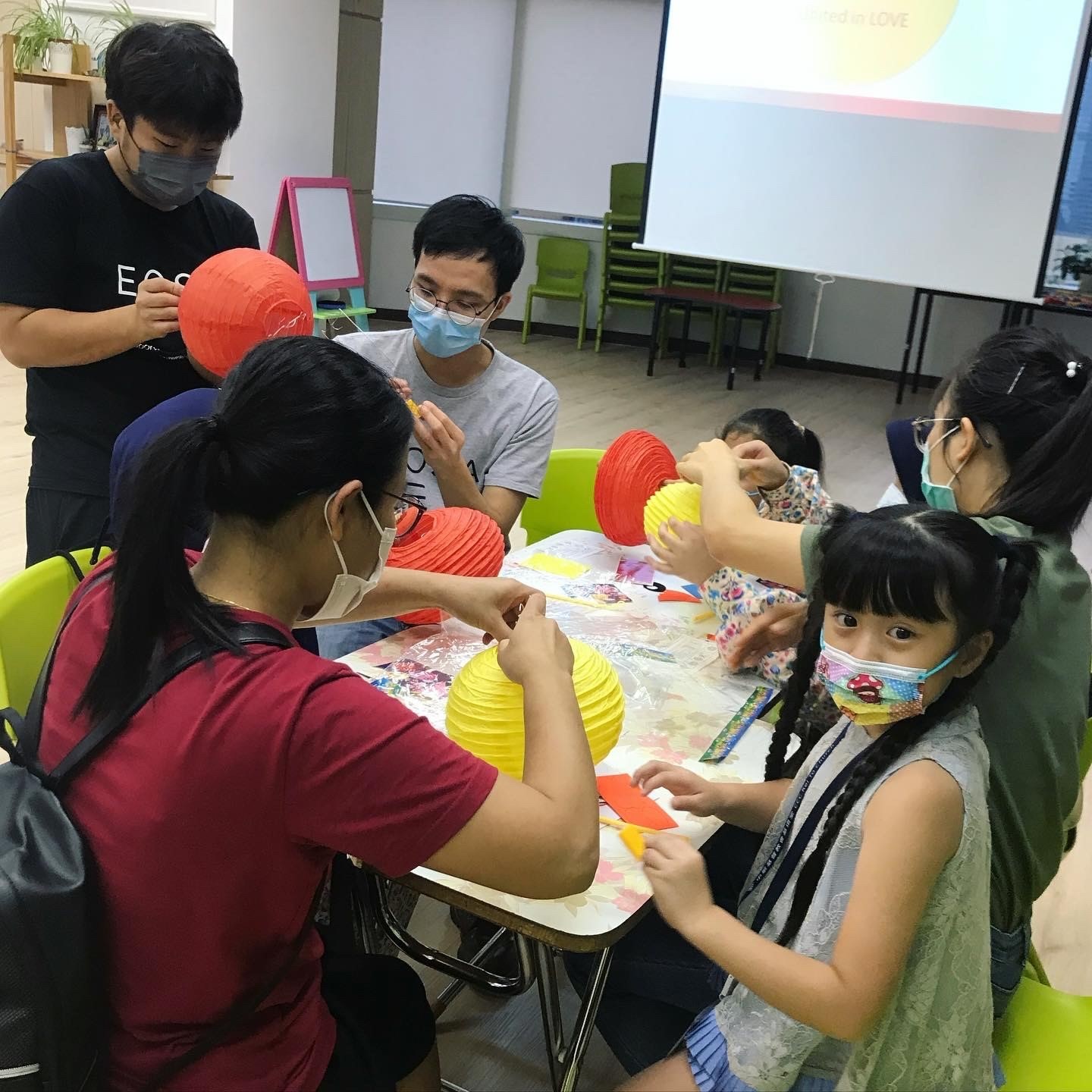 Photo of EOSA Service Day: Two EOSAs making lantern together with the children